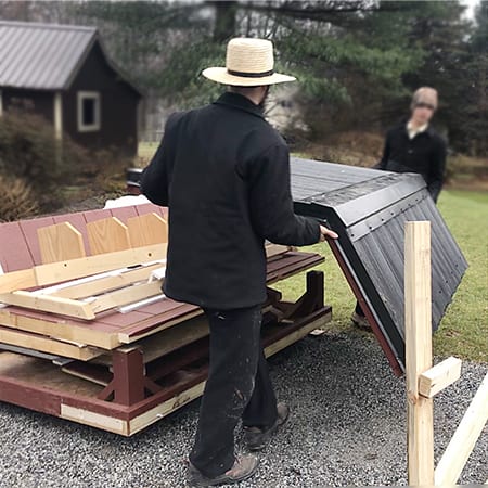 050201_amish_chicken_coop_kits_black_metal_insulated_roof_two_men_carrying_into_backyard_450x450_1